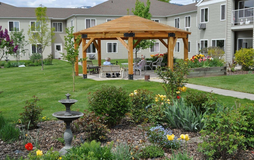 photo of backyard with large gazebo and flower garden